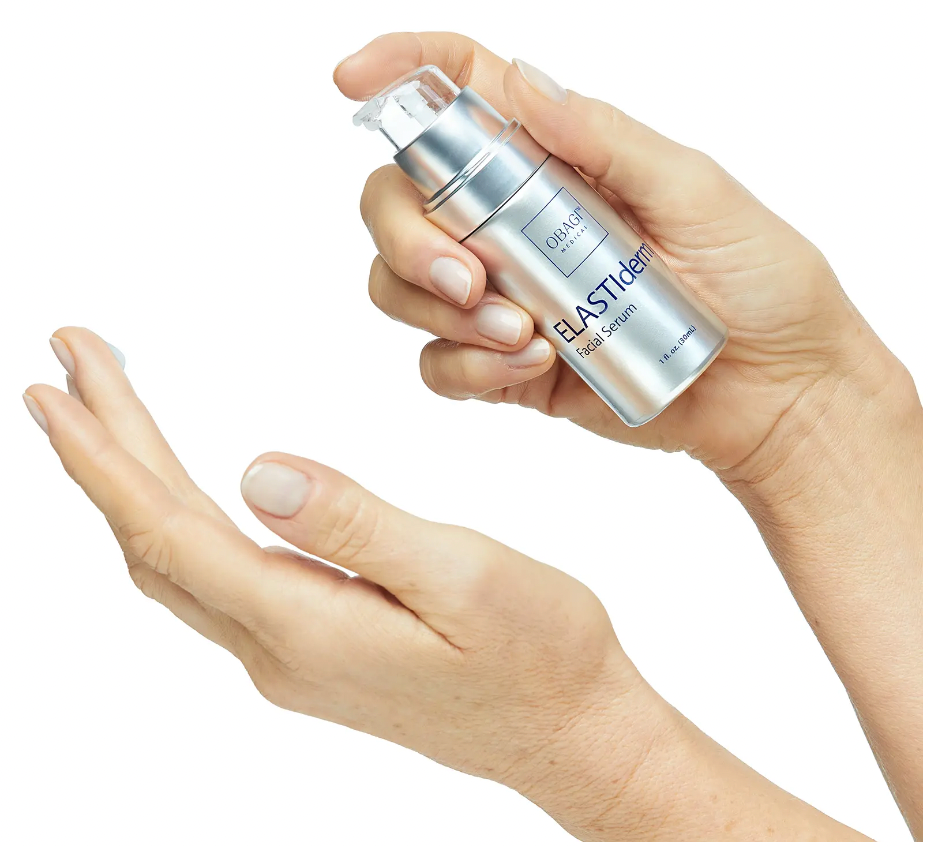 Woman applying Elastiderm Facial Serum